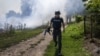 A journalist runs amid shelling in Bakhmut, eastern Ukraine, in July 2022.