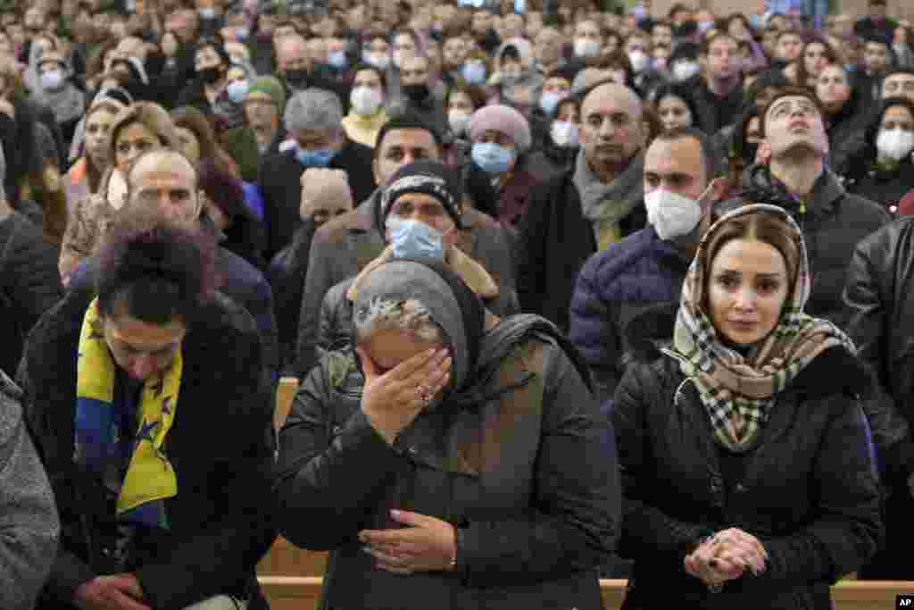 Women weep during a church service held in Yerevan on December 19. 