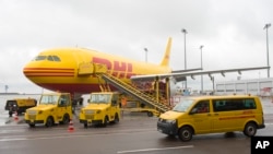 Reports said the devices ignited in July in depots of global courier DHL in the British city of Birmingham and the German city of Leipzig.