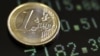 Italy -- A picture illustration shows a one euro coin on a flat screen displaying exchange rates in Rome, 08Dec2011