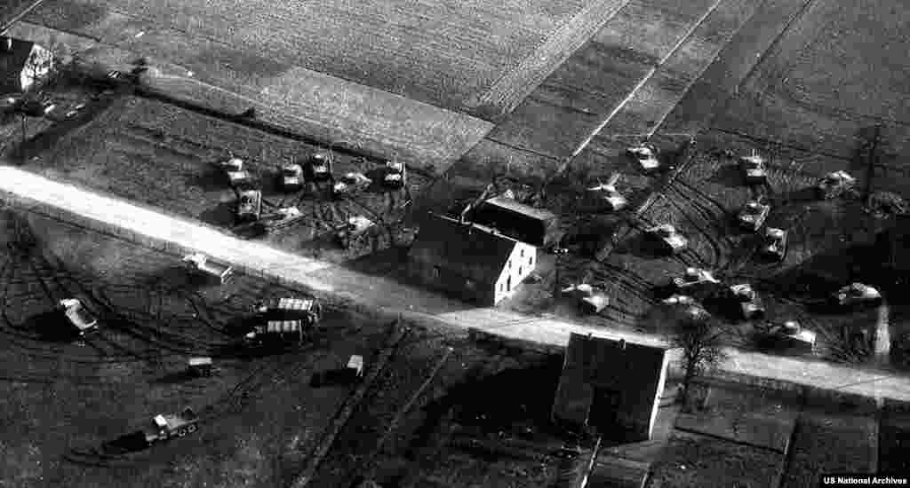 This scene of fake Allied armor was created by running caterpillar vehicles over soft grass, then placing inflatable vehicles in the tracks. The activities of the "Ghost Army" remained secret until 1985.