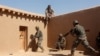 A U.S. Marine watches Afghan soldiers during training in Helmand Province.
