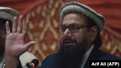 The Pakistani head of Jamaat-ud-Dawa (JuD), Hafiz Saeed, speaks at a press conference in Lahore on January 23.
