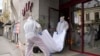 Forensic workers carry the body of Gholamreza Mansuri from the Duke Hotel in downtown Bucharest.
