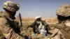 An Afghan farmer speaks with a U.S. Marine officer in Marjah in 2010.