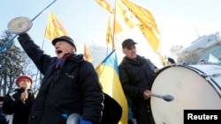 Demonstrators shout slogans while they take part in a rally of depositors in failed Ukrainian banks who demanded compensation of their deposits, in front of the parliament building in Kyiv on November 15.