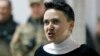 Ukrainian lawmaker Nadia Savchenko reacts inside a defendants' cage during a court hearing in Kyiv on March 23. 