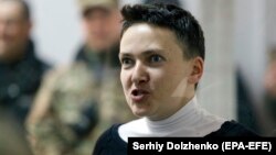 Ukrainian lawmaker Nadia Savchenko reacts inside a defendants' cage during a court hearing in Kyiv on March 23. 