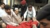 An injured man is taken into a hospital in Peshawar after a suicide bomber struck a military convoy. At least 41 people were killed in the attack.