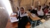 Afghan school girls attend a class at a makeshift camp in Herat in April 2015.