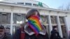A transgender rights activist stands in a park for a rally on November 18. Organizers were forced to abandon the event after far-right counterdemonstrators assaulted several protesters and attacked a Canadian journalist.