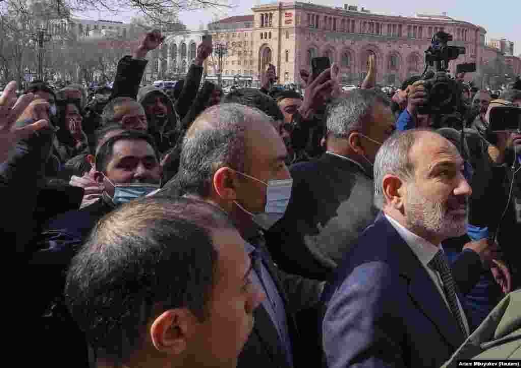 Armenian Prime Minister Nikol Pashinian (right) walks with supporters in central Yerevan. The embattled leader has faced weeks of protests over his handling of the recent conflict with Azerbaijan. 