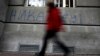 A man walks past graffiti in the Serbian capital, Belgrade, that reads "Never in EU."