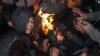 Afghan children gather around a fire to beat the cold in Kabul. (file photo)