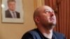 Russian dissident journalist Arkady Babchenko, whose name was not on the alleged "Russian hit list," speaks to the media on May 31 following his faked death, as a portrait of President Petro Poroshenko hangs on the wall behind him.