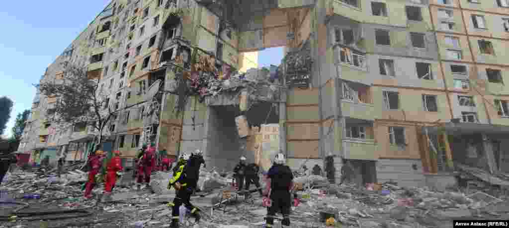 Rescue teams at the scene of a Russian strike on an apartment block in Kharkiv on September 24. Kharkiv Mayor Ihor Terekhov announced that two residential areas in the northeastern city of Ukraine had been hit with Russian glide bombs, killing at least three people. 